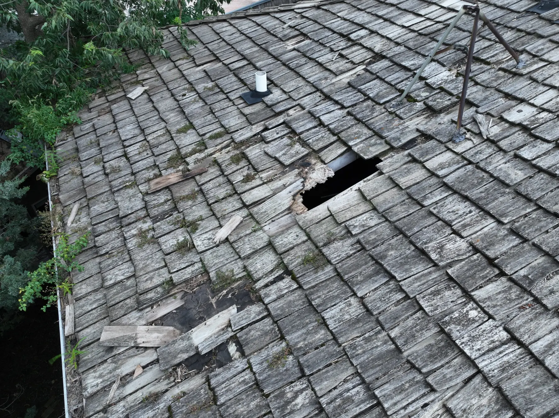 Badly deteriorated wood-shingle roof needing major repair